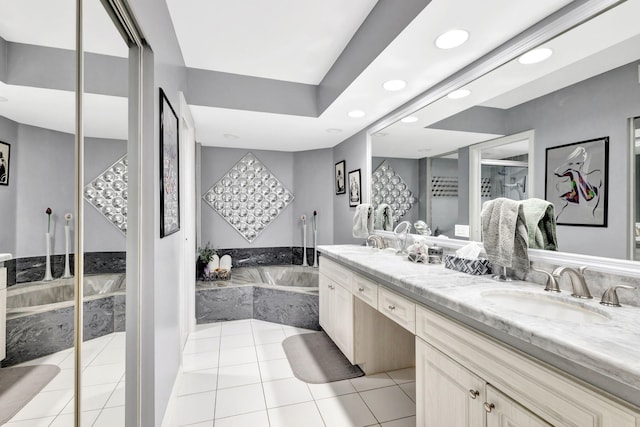 bathroom featuring tile patterned floors, a garden tub, a sink, and double vanity