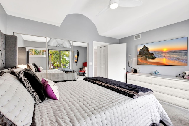 carpeted bedroom featuring lofted ceiling, ceiling fan, and visible vents