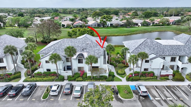 drone / aerial view with a water view and a residential view