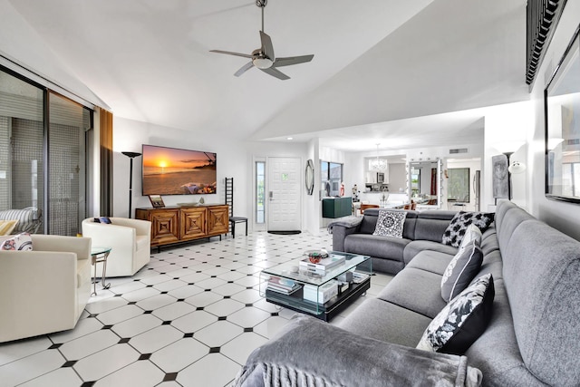 living room with light floors, visible vents, high vaulted ceiling, and ceiling fan with notable chandelier