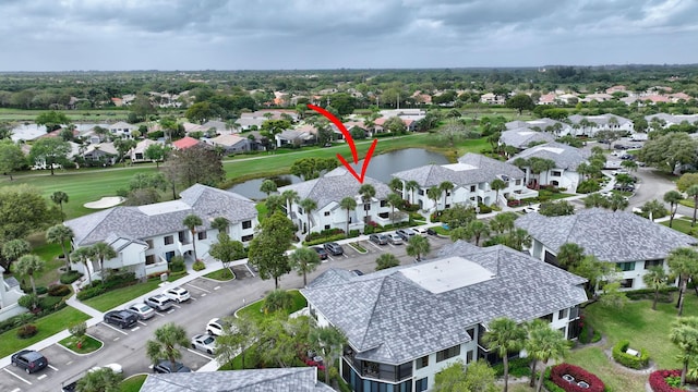 birds eye view of property with a water view and a residential view