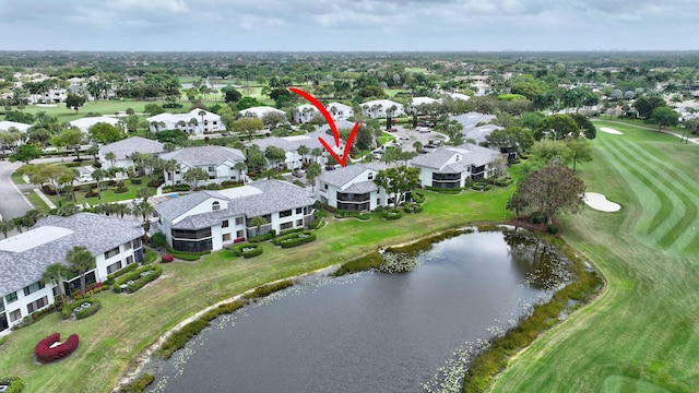 aerial view with view of golf course, a water view, and a residential view