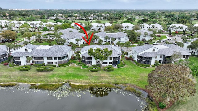 drone / aerial view with a residential view and a water view