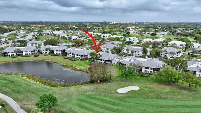 drone / aerial view with a residential view, a water view, and golf course view