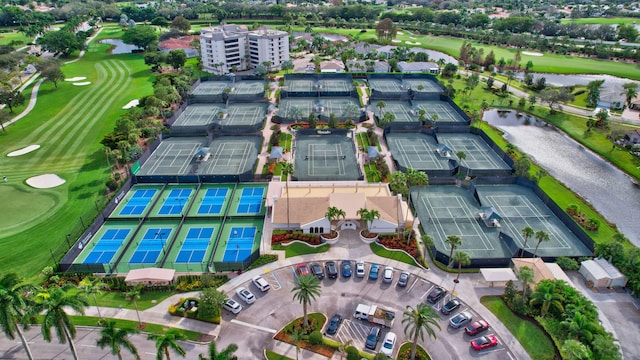 birds eye view of property featuring golf course view and a water view