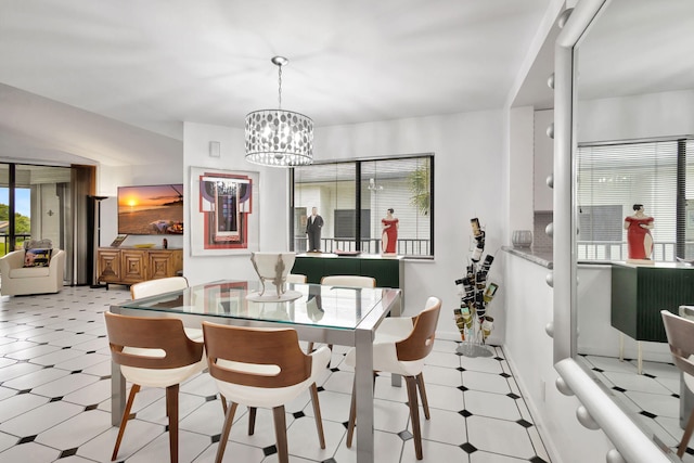 dining area with light floors, baseboards, and a chandelier