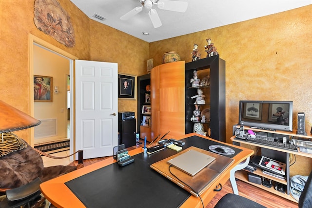 office area featuring wood finished floors, visible vents, and a ceiling fan