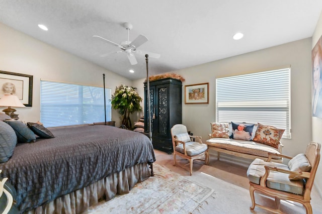 bedroom featuring light carpet, ceiling fan, multiple windows, and vaulted ceiling