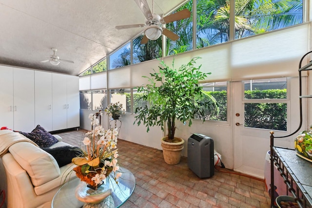 sunroom featuring vaulted ceiling and a ceiling fan