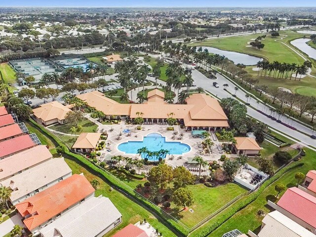 drone / aerial view with a residential view, a water view, and golf course view