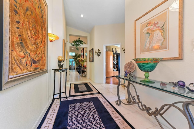 hall featuring vaulted ceiling and tile patterned floors