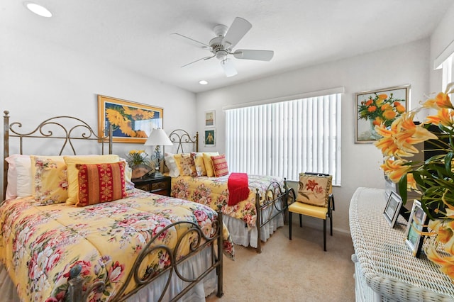 bedroom featuring ceiling fan and carpet