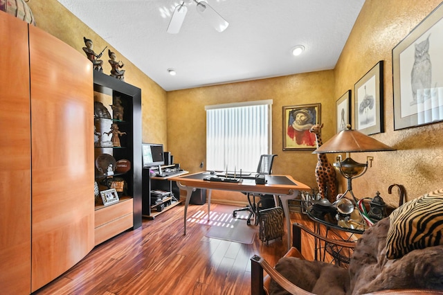 office space featuring ceiling fan, a textured wall, and wood finished floors