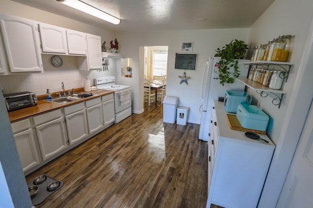 kitchen featuring electric range, a sink, wood counters, dark wood-style floors, and tasteful backsplash