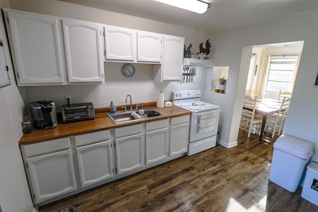 kitchen featuring dark wood-style flooring, white range with electric cooktop, decorative backsplash, a sink, and wood counters