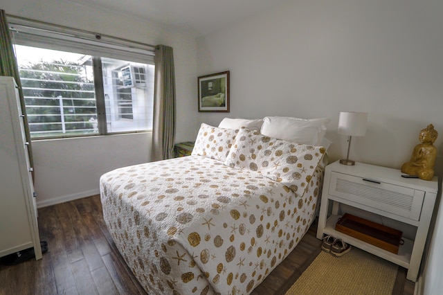 bedroom featuring dark wood-type flooring and baseboards