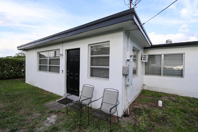 exterior space with a front yard and stucco siding