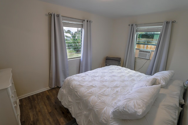 bedroom with dark wood-style floors and baseboards