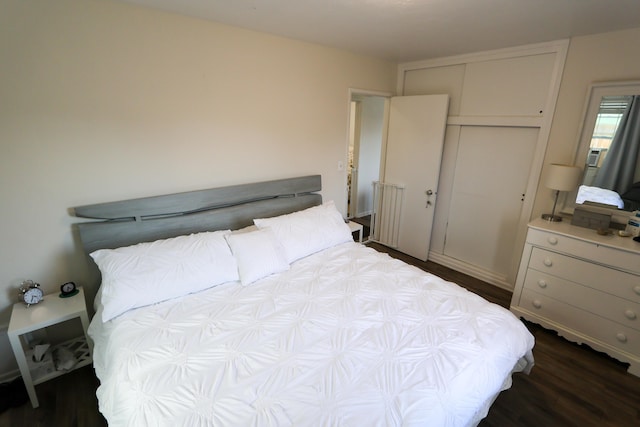 bedroom with dark wood-style flooring and a closet