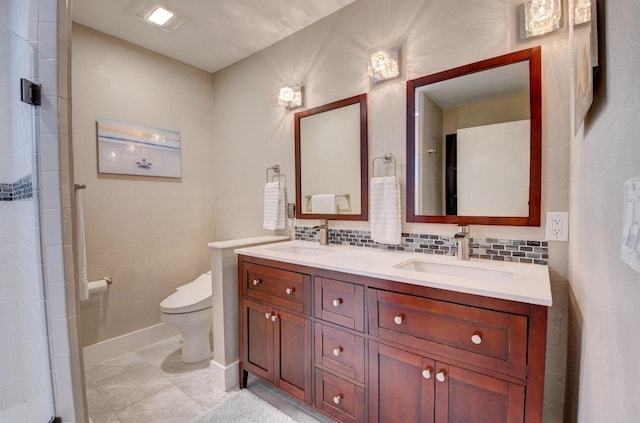 full bath featuring double vanity, toilet, tasteful backsplash, and a sink