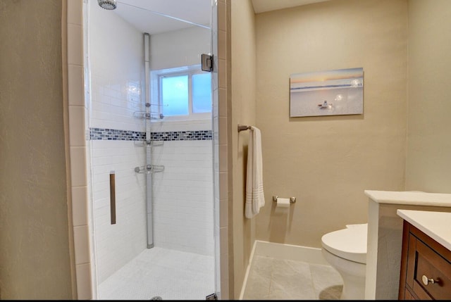 bathroom featuring toilet, a stall shower, and vanity