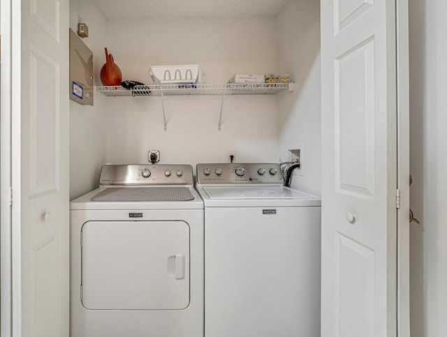 clothes washing area featuring laundry area and separate washer and dryer