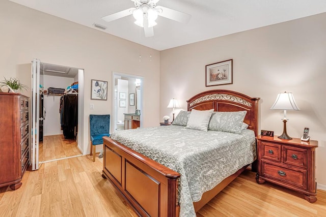 bedroom with ceiling fan, visible vents, a spacious closet, a closet, and light wood finished floors