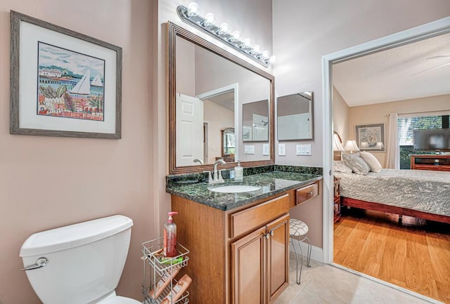 bathroom with tile patterned floors, vanity, toilet, and ensuite bathroom