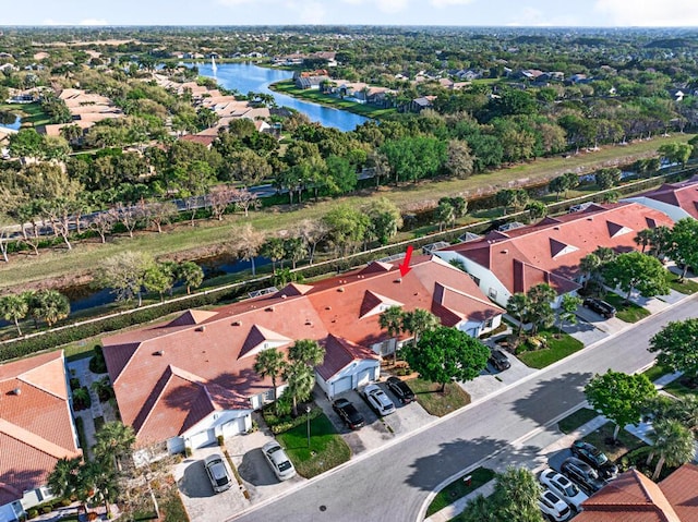 drone / aerial view with a water view and a residential view