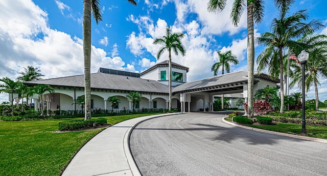 view of building exterior with curved driveway