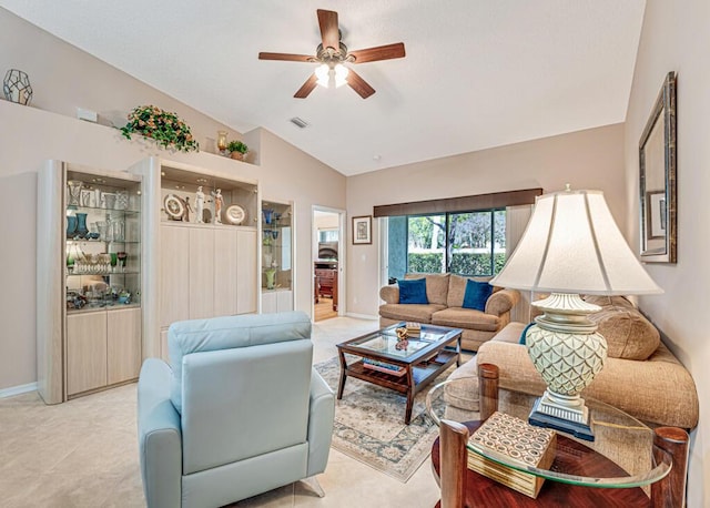 living area with lofted ceiling, ceiling fan, visible vents, and baseboards