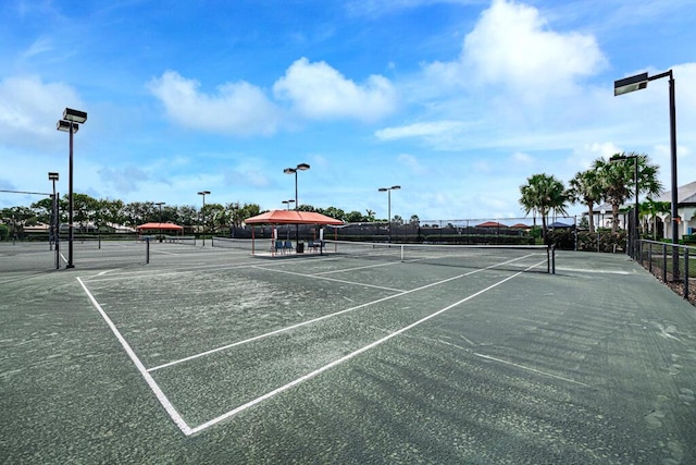 view of sport court featuring fence