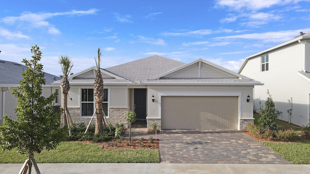 view of front of property with a garage, stone siding, decorative driveway, and stucco siding