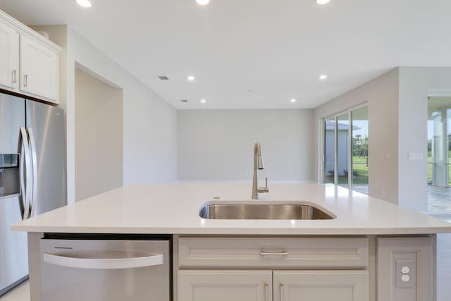 kitchen featuring stainless steel appliances, a sink, and light countertops