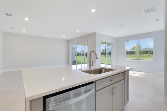 kitchen featuring a healthy amount of sunlight, dishwasher, open floor plan, and a sink