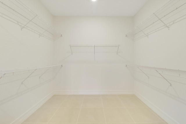 spacious closet featuring light tile patterned floors