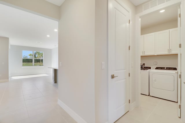 hall with recessed lighting, light tile patterned flooring, washer and clothes dryer, and baseboards