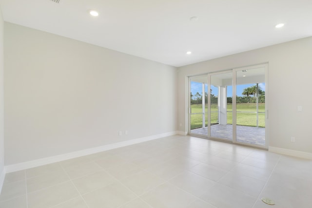 empty room with light tile patterned floors, recessed lighting, and baseboards