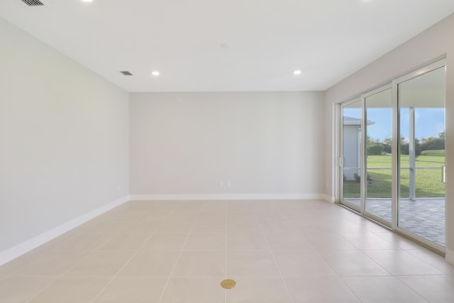 spare room featuring light tile patterned floors, baseboards, and recessed lighting