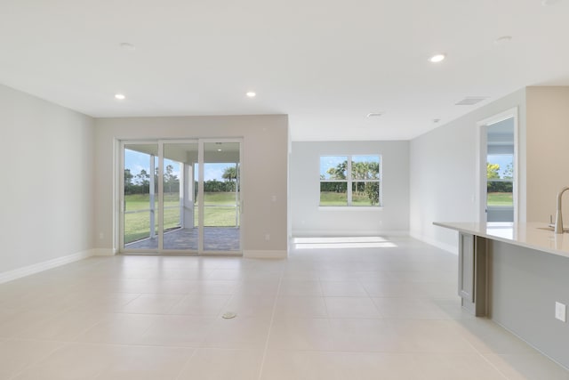 spare room with light tile patterned floors, baseboards, and recessed lighting