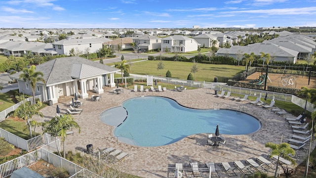 pool featuring a residential view, fence, and a patio