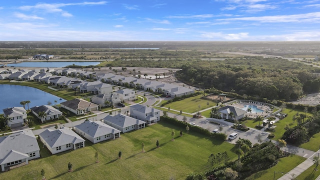 birds eye view of property featuring a water view and a residential view