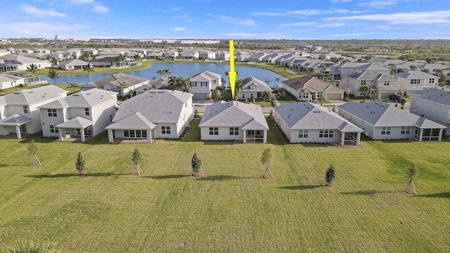 drone / aerial view with a water view and a residential view