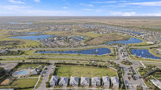 drone / aerial view with a residential view and a water view