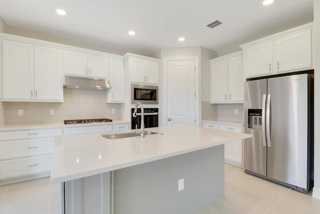 kitchen with light tile patterned floors, appliances with stainless steel finishes, visible vents, and under cabinet range hood