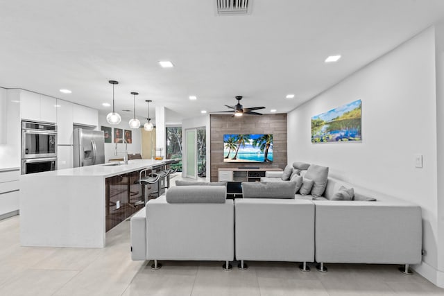 living room with a ceiling fan, light tile patterned flooring, visible vents, and recessed lighting