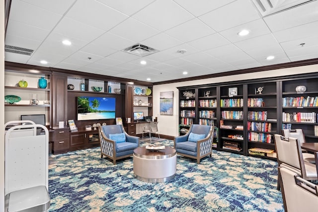 sitting room featuring built in shelves, carpet, visible vents, and crown molding