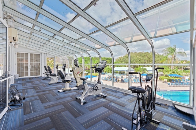 gym featuring vaulted ceiling, a wall mounted AC, and carpet flooring