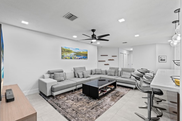 living area with recessed lighting, visible vents, ceiling fan, and baseboards