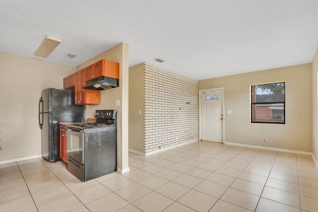 kitchen featuring light tile patterned floors, baseboards, visible vents, under cabinet range hood, and black appliances